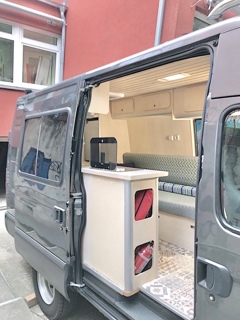 Open sliding door showing kitchen and bench